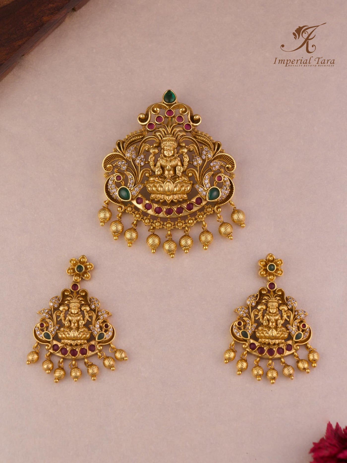 Damini gold pendant set in Lakshmi pattern with peacock design.