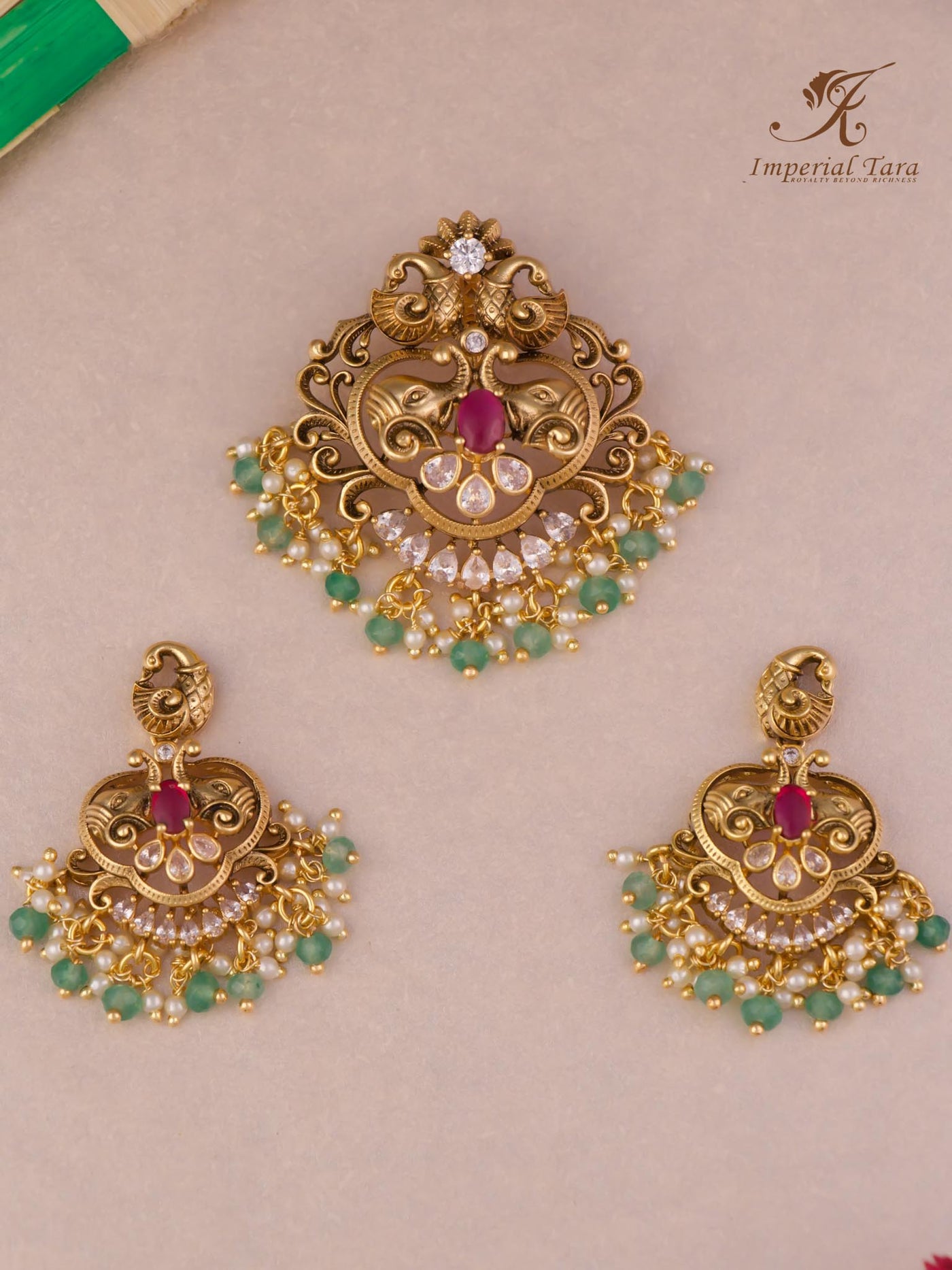 Gold finish pendant set in elephant design  with ruby stone & mint bead hangings