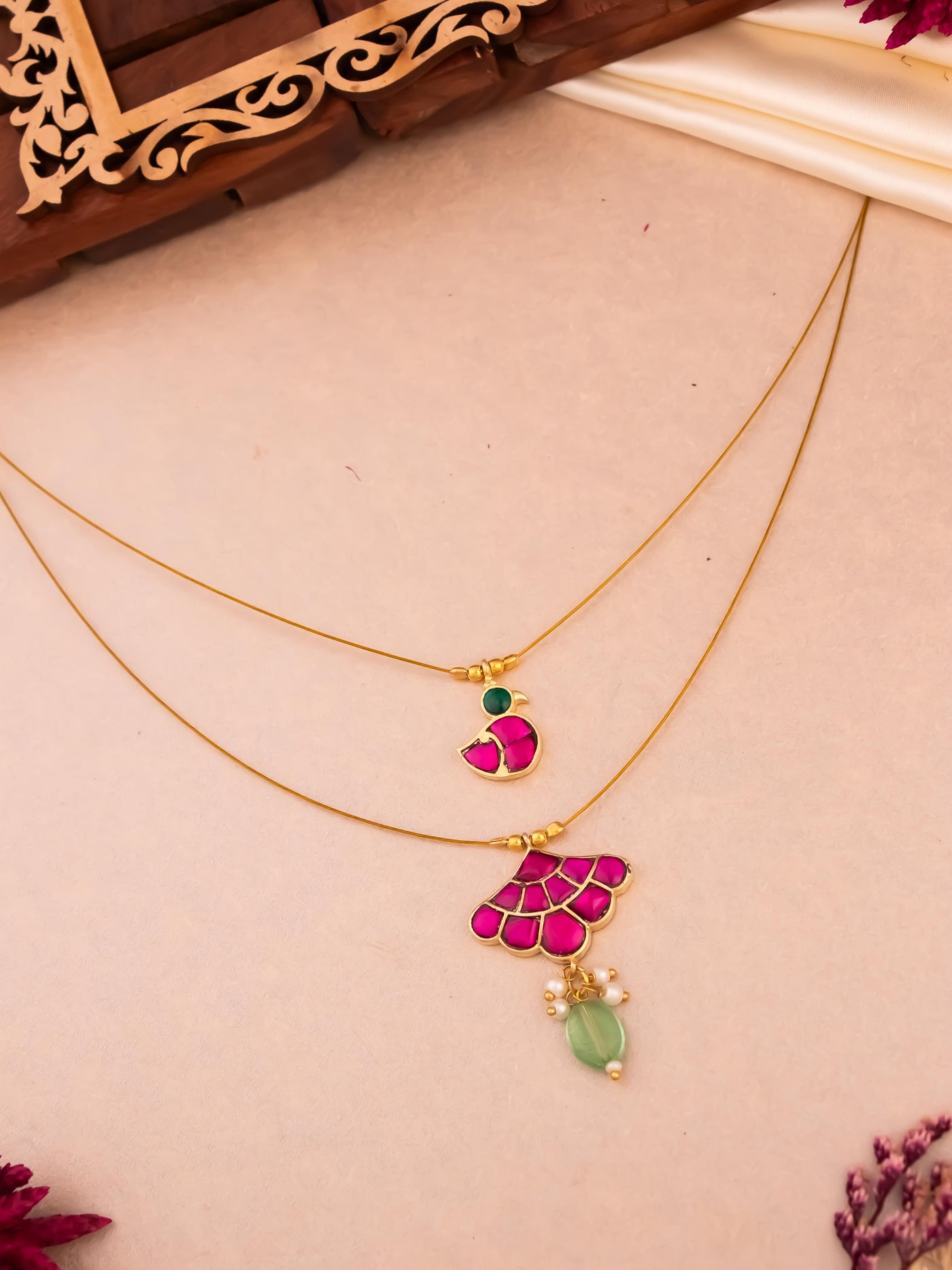 Modern invisible necklaces featuring Jadau and Kundan stones in duck and flower patterns.