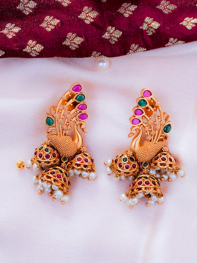 Three layered peacock short haram with beads jhumkas hanging to the earrings in real kemp, temple Jewellery