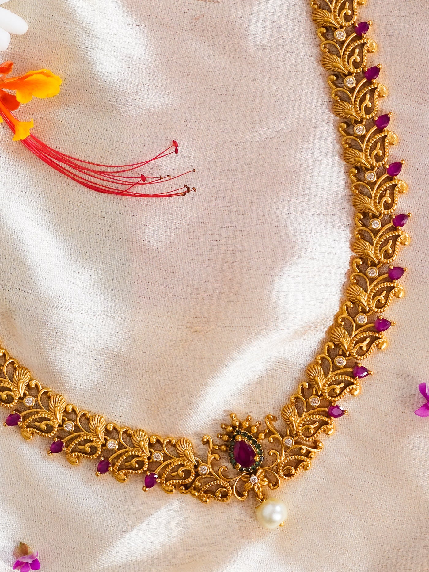 Details of finely detailed ruby short harm temple necklace set